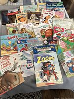 Full display of all children's softcover books laid out for viewing.