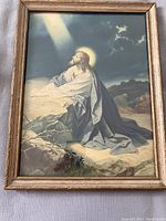 Framed color print depicting Christ praying in the Garden of Gethsemane at night with a glowing halo, medium size frame with gold trim.
