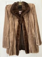 Front view of the ladies mink fur jacket showing beige fur with darker brown collar and front edge.