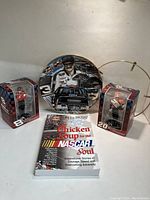 Full lot with Nascar collector plate, book, and two Christmas tree decorations in original boxes.