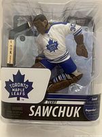 Front view of the sealed NHL Terry Sawchuk figure packaging showing the figure in Toronto Maple Leafs gear.