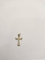 Photo of the 10k gold cross pendant against a white background.