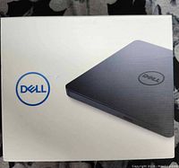 Photo of the box front showing image of the Dell USB Slim DVD Drive and Dell logo