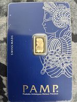 Gold bar in blue PAMP Suisse card showing Lady Fortuna artwork and SWISS MADE marking