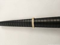 Ring placed on black plastic mandrel showing band profile and sizing.