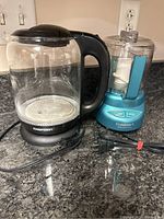 Chefman electric kettle and Cuisinart mini chopper on a kitchen counter.