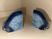 Pair of blue geode rock bookends shown from the front, polished crystal faces visible.