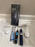 Photo showing all toothbrushes, charging bases, and boxed Sonic Electric Toothbrush