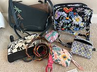 Entire lot including all purses, pouches, bag and woven belt laid out on carpet floor with visible Chala branded bag and various floral and patterned pouches.