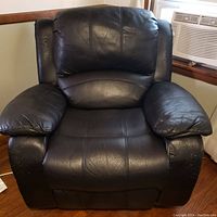 Front view of the black leather Faix recliner chair showing the cushioned seat, backrest, and padded armrests.