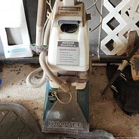 Front-close view of the Hoover SteamVac carpet cleaner showing dirt brush button and model details.