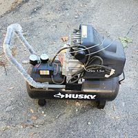 Side view showing the full compressor with dual gauges, motor, and tank with HUSKY logo.