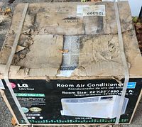 Original box with LG branding, model number LW1210ER, size and features listed, heavy wear and damage from storage visible.