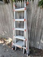 Ladder folded at angle showing multiple sections and platform step
