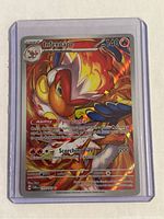 Front view of holographic Infernape Pokémon card in protective hard plastic case showing card art, HP, and text.