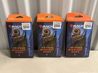 Photo of three sealed Magic The Gathering Innistrad Midnight Hunt Theme Booster Blue packs, each includes 35 cards.