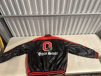 Full back view of the black leather bomber jacket with red yoke and large embroidered Ohio State logo.