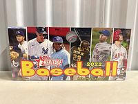 Front view of sealed Topps Heritage 2022 Baseball trading card box showing player images and branding.