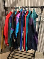 Rack view showing eight assorted nylon jackets on hangers