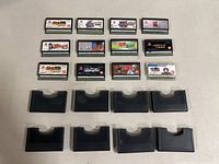 14 Japanese Super Famicom cartridges arranged on table with some in protective cases.