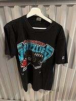 Front view of the black Vancouver Grizzlies t-shirt with large graphic bear holding basketball.