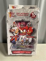 Sealed pack of 2021 Wild Card Alumination football cards featuring three players on front and branding.