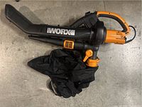 Top view of the Worx branded electric leaf blower vacuum showing attached fabric collection bag and blower nozzle.