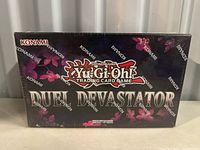 Front of sealed Duel Devastator booster box showing title and Konami branding