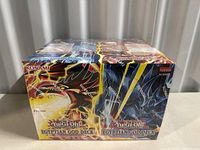 Front view of both sealed Yu-Gi-Oh! Egyptian God Deck boxes showing artwork of Slifer the Sky Dragon and Obelisk the Tormentor and sealed packaging.