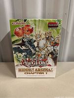 Front view of the sealed Yu-Gi-Oh! Hidden Arsenal Chapter 1 booster box showing vibrant artwork and branding, shrink-wrapped and unopened.