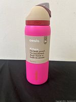 Front view of pink Owala water bottle with label mentioning insulation and leak-proof features