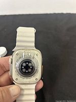 Back of watch showing sensors and engraved text around perimeter