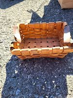 Photo of the rectangular woven basket showing wood weave and leather handles
