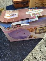 Closed original box of Babycakes cake pop maker with colorful branding and photos of cake pops on the box.