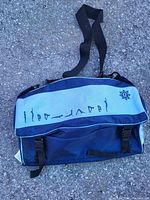 Blue carry bag with yoga pose graphics and shoulder strap shown closed from top view.