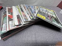 Stack of 40 Batman comic books individually bagged, showing colorful spines and covers.