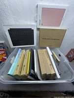 Overview of the bin with various new device protectors and covers including keyboard covers and boxed cases.