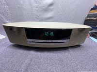 Front view of Bose Wave Music System showing time on digital display and overall condition.