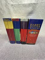 Front side view of four Harry Potter hardcover books in a labeled Harry Potter boxed set.