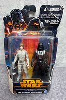 Front view of sealed Star Wars Mission Series packaging showing Luke Skywalker and Darth Vader 9.5cm figures, some wrinkles on packaging.