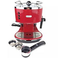 Front view of the red coffee maker with attached water reservoir, drip tray, and accessories including portafilter and two filter baskets placed in front.