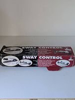Box front and top showing Husky Sway Control label and product images with usage info.