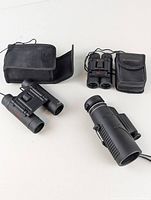 Lot overview showing all three binocular items with protective cases or pouches