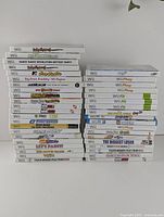 Two stacks of Nintendo Wii game cases showing spines of multiple titles