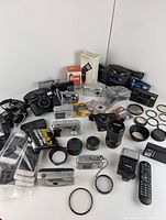 Overview of all items including cameras, smartphones, lenses, flashes, and accessories spread on a flat surface.