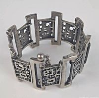 Full view of Robert Larin signed pewter bracelet featuring textured panels and chain closure with pin.