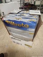 Box containing six 3-pack Filtrete Basic air cleaning filters with visible brand and size marking 14x20x1 on the box.