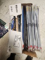 Box partially open showing 11 Filtrete 20x20x1 sized air filters in protective plastic bags.