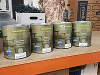 Four 1-gallon cans of GreenSheen Eco-Friendly Paint labeled for interior/exterior use in Sage color.