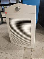 Full front view of Hamilton Beach air purifier showing intake grille and top control.